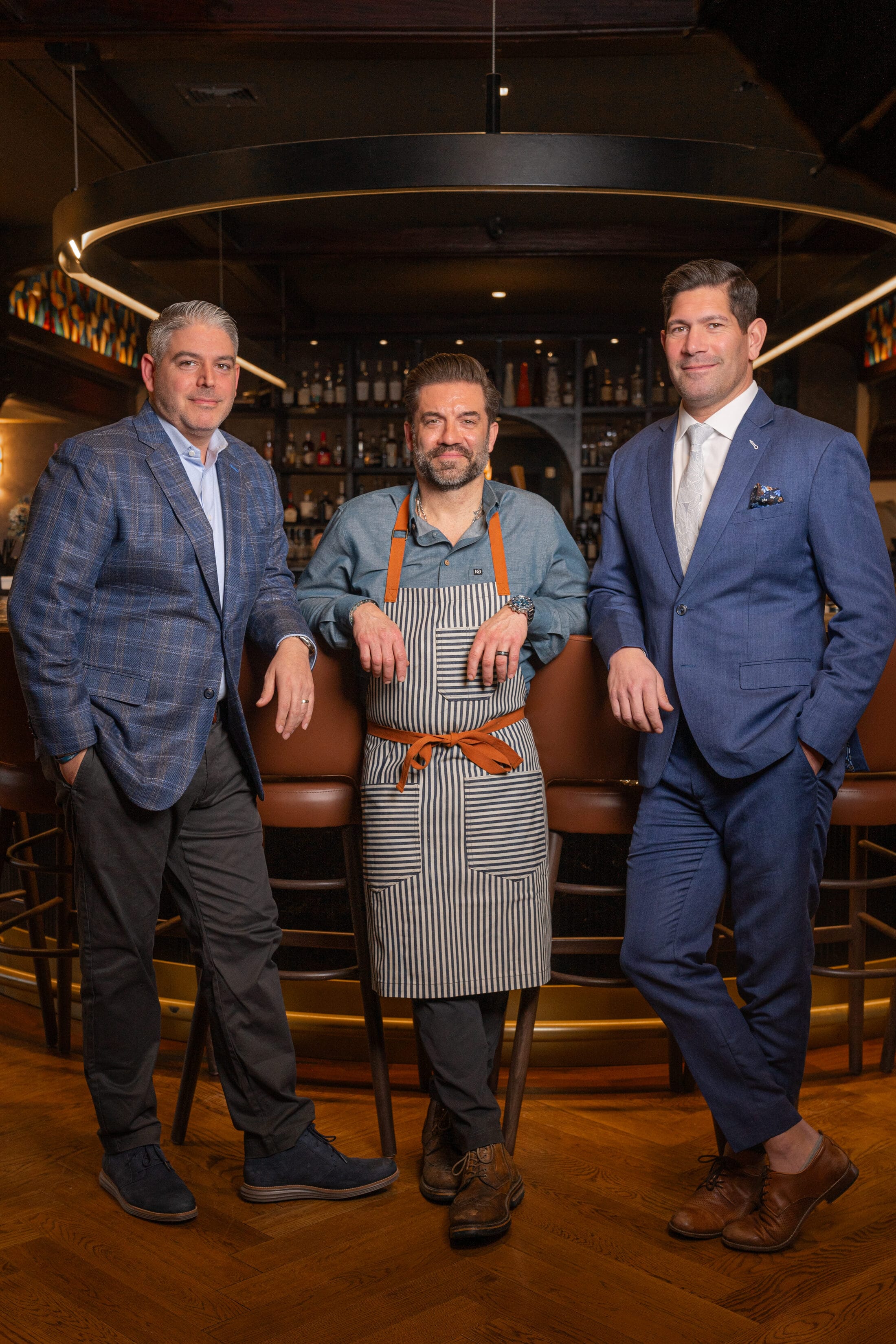 The three partners behind Ember & Eagle at the bar